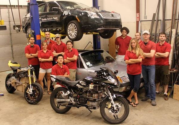 The MIT Electric Vehicle Team poses with the vehicles they have converted to electric power. Team member Lennon Rodgers, second from right, will be presenting results of their work at a conference in Montreal.