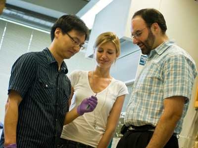 Postdoctoral associate Jae-Hee Han, left, graduate student Geraldine Paulus and associate professor Michael Strano built a fiber of carbon nanotubes that can concentrate solar energy.
