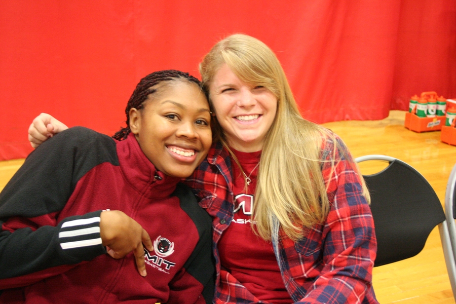 Assistant Women’s Basketball Coach Erica Gunn, left, helps one of her players, sophomore basketball and soccer player Stephanie Cook, right, prepare for a different kind of contest. “The dating game” featured three male contestants — all MIT basketball players, with two posing as students from Caltech and Harvard — competing for a date with Cooke.