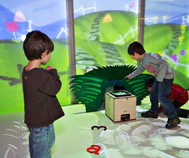 In the prototype of the Media Lab's Playtime Computing environment, the Alphabot disappears into a hutch covered by robotic foliage and appears to continue moving along a path in a virtual world.