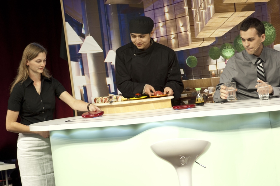 The Silver team — which designed a disc-shaped robot for delivering plates of sushi in a restaurant — shows how customers would use their product.