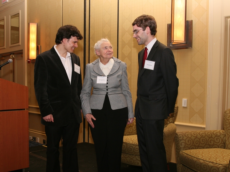 Pablo Jarillo-Herrero, assistant professor in the Department of Physics, left, and Tomas Palacios, the Emmanuel E. Landsman (1958) Career Development Associate Professor, talk with the honoree.