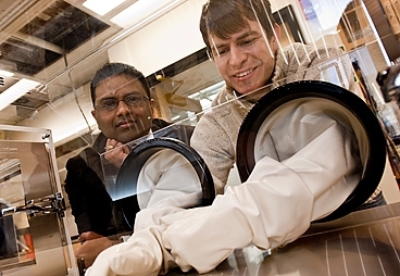 MIT assistant professor Kripa Varanasi (left) and graduate student J. David Smith work with a cold stage, a system for cooling materials in a precisely controlled way, to study frost formation.