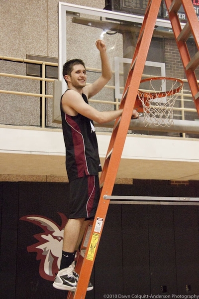 Erik Zuk ’11 takes his turn with the post-championship tradition of cutting down the net.