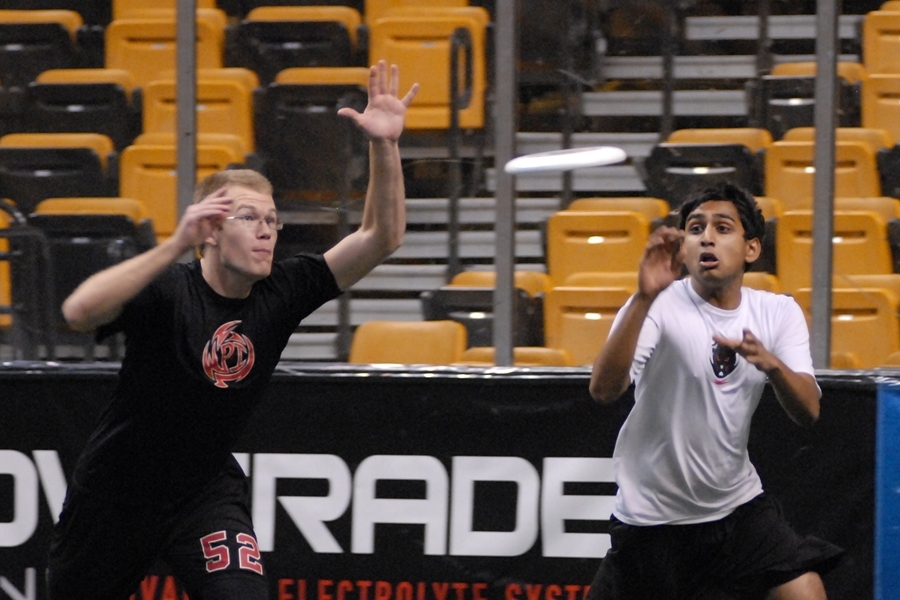 Senior Kesavan Yogeswaran, right, beats his defender to catch a pass on offense. Because the rink was smaller than a standard ultimate field, players had less space than usual to make their cuts.