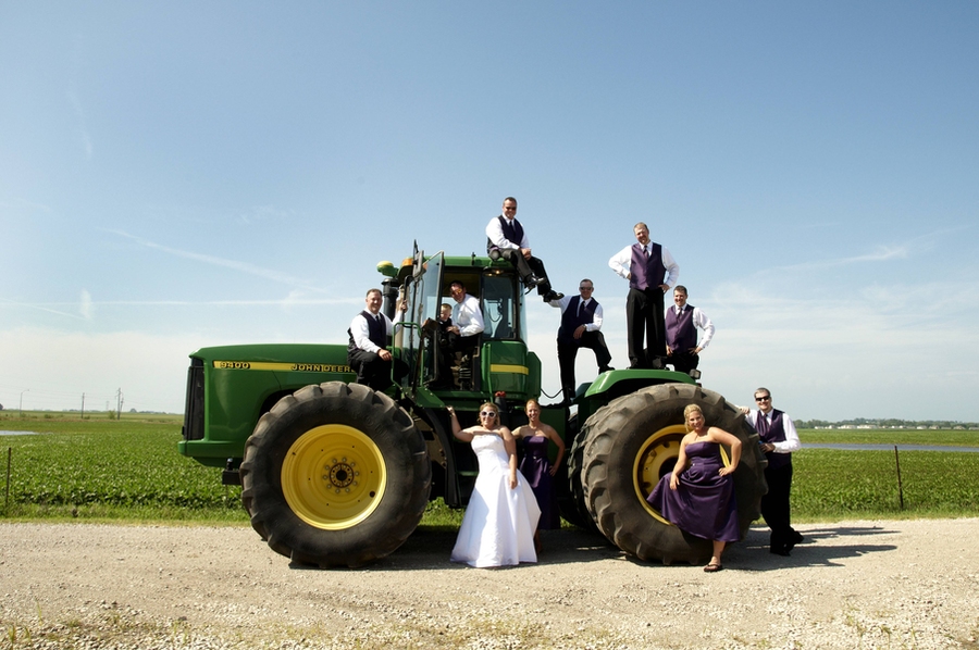 Candice Engler, senior product engineer at Deere & Company, her husband, Ben, and their wedding party with a John Deere 9400.
