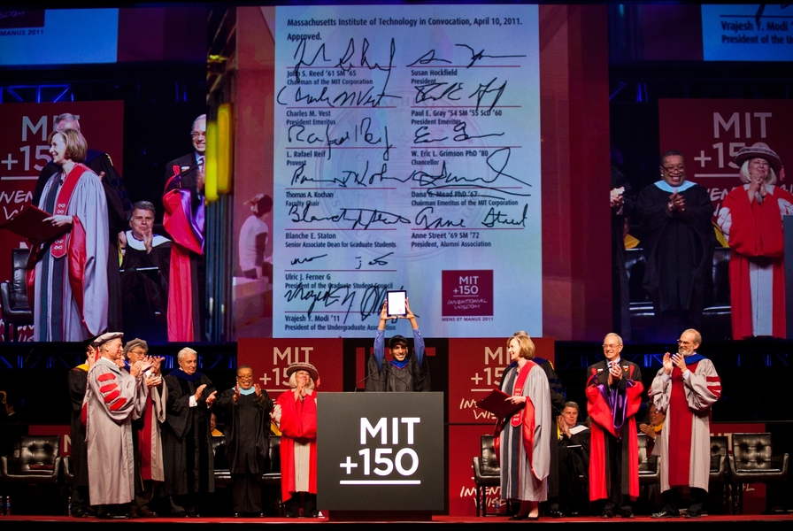 MIT Undergraduate Association President Vrajesh Modi holds up an 'iCharter' signed by representatives of various parts of the MIT community.