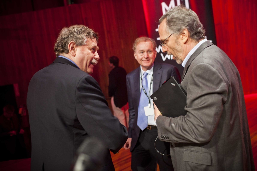 After the 'Life Sciences' session, two of the presenters, MIT Professor of Biology and Broad Institute Founding Director Eric Lander, left, and David Shaw, right, chief scientist at D.E. Shaw Research, discuss Shaw’s presentation as session chair Dave Gifford, a computational genomicist, looks on.