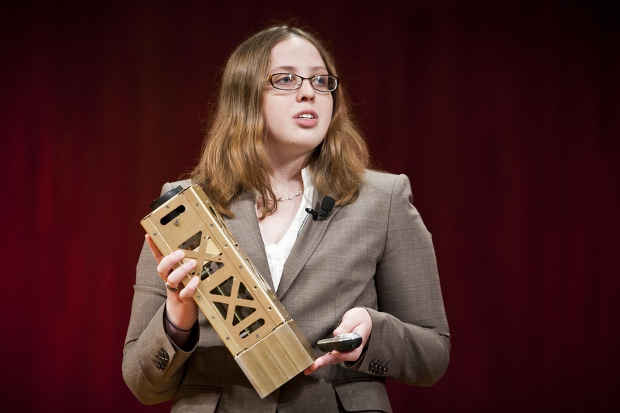 MIT senior Mary Knapp presents a prototype of a small satellite at the XCOR Student Showcase Competition. Knapp won first place for her concept, SOLARA, a constellation of small satellites that track exoplanets in deep space.