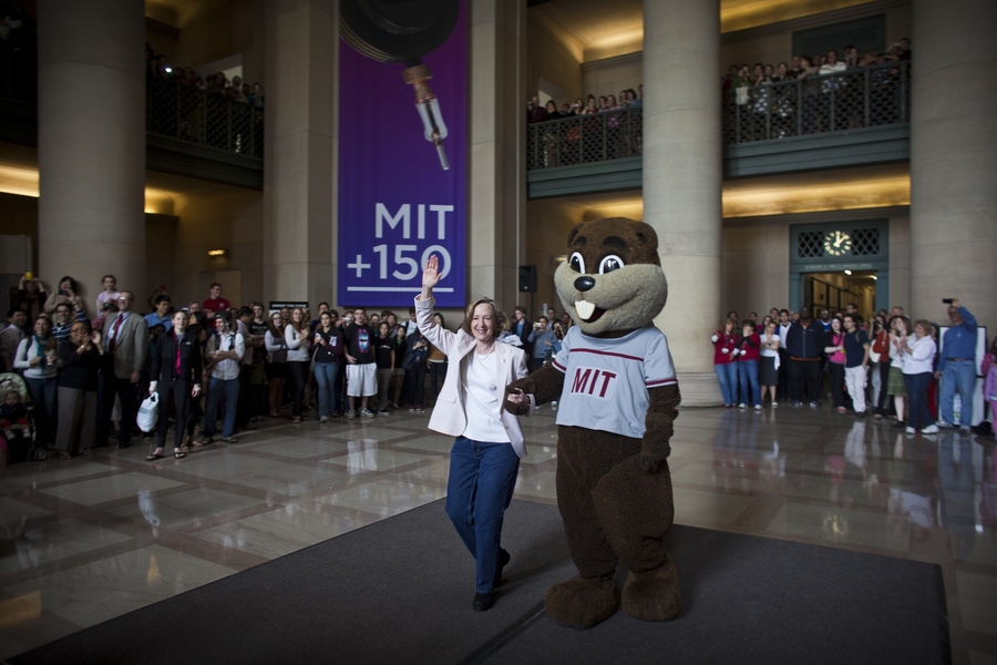 MIT President Susan Hockfield and Tim the Beaver walk out of Lobby 7 after a flash mob broke out there around noon.