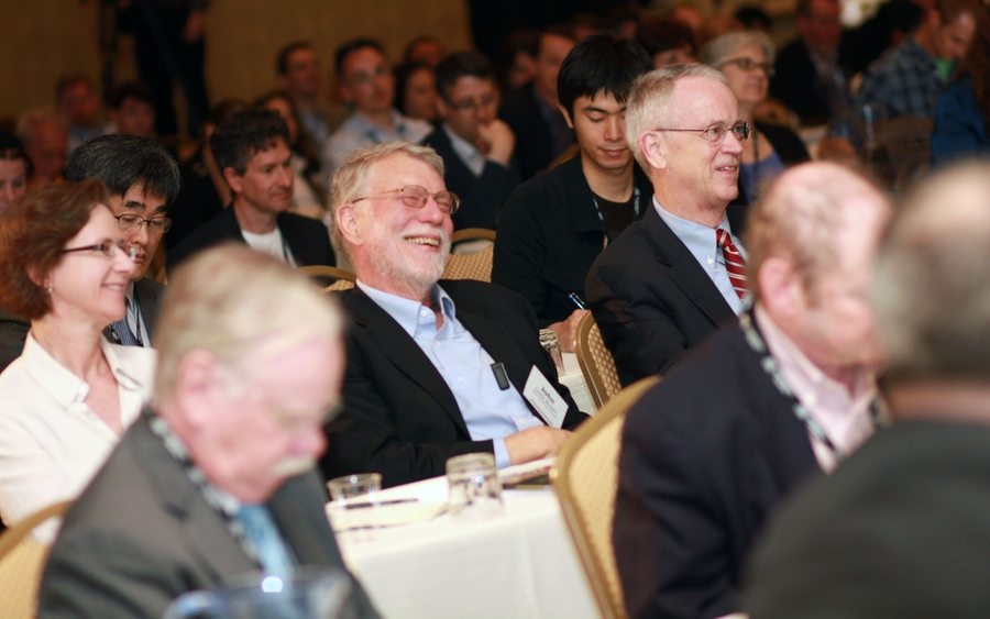 Attendees at the Wednesday opening event of the OCW Consortium Global 2011 included John Seely Brown, center, the former chief scientist of Xerox Corporation, and MIT President Emeritus Charles M. Vest, right.