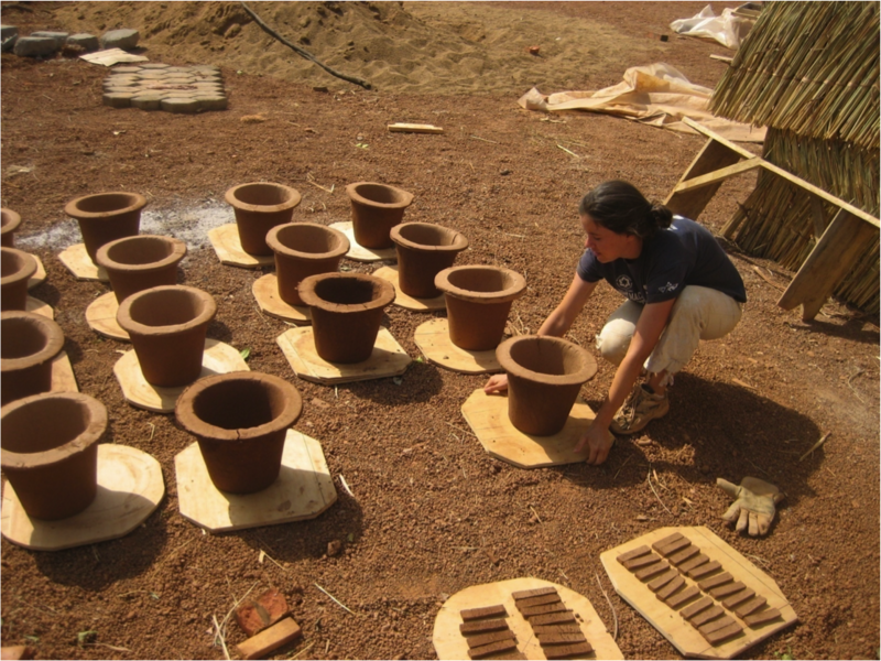 After molding, the clay pots are dried in the sun before being fired in the kiln.
