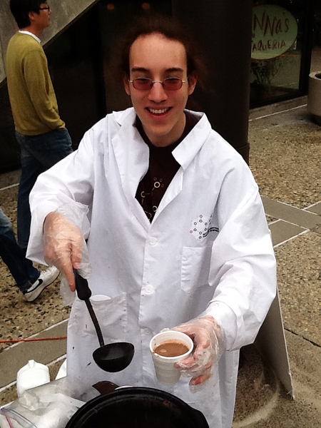 Junior Jayson Lynch, vice president of the MIT Laboratory for Chocolate Science, ladles up free hot cocoa in front of the student center.