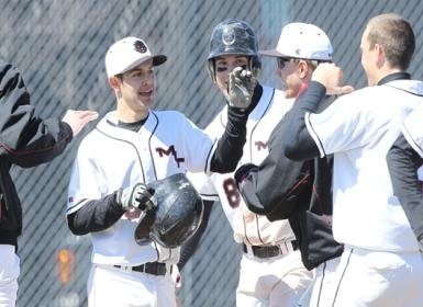 Junior Bryan Macomber celebrates with teammates. 