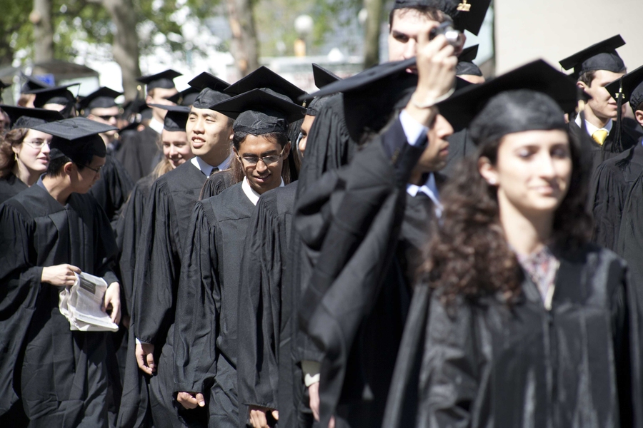 The student procession makes its way from Rockwell Cage down Massachusetts Avenue.