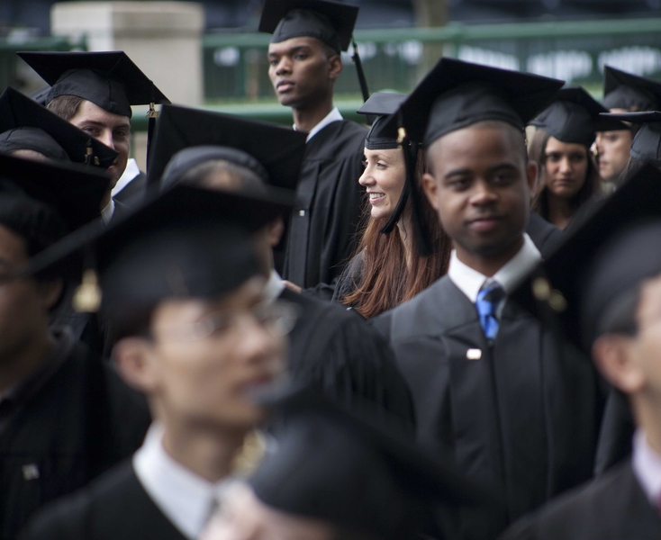 The student procession makes its way from Rockwell Cage down Massachusetts Avenue.