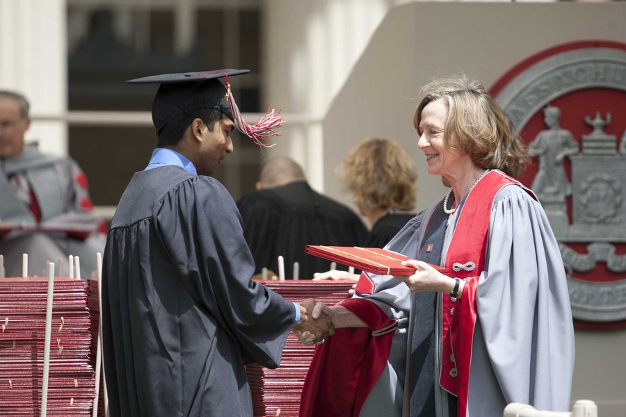 MIT President Susan Hockfield presents Vrajesh Modi with his diploma.