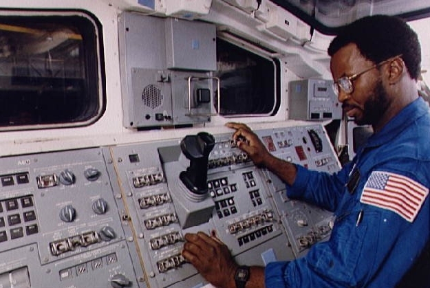 Ronald McNair PhD '77 was one of seven astronauts who died in the Space Shuttle Challenger. In this 1983 photo, he trains on the remote manipulator system (RMS) simulator.