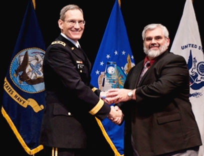 Lieutenant General Patrick O'Reilly, MDA director, left, presents the Pinnacle Award trophy to David Conrad at the annual MDA awards ceremony.