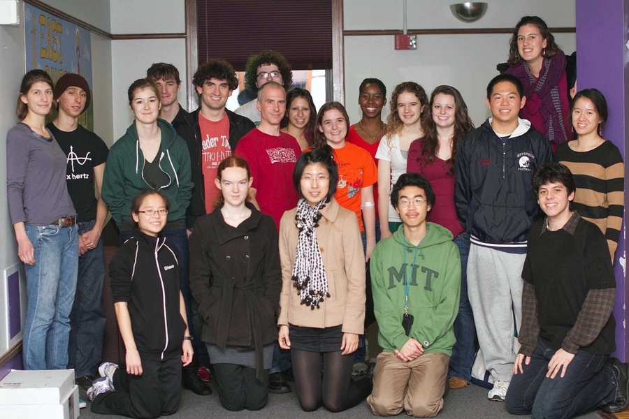 Bon Appétit chef Brian McCarthy (red shirt, center) poses with students at a vegan cooking class in East Campus, one of MIT's cook-for-yourself dormitories.