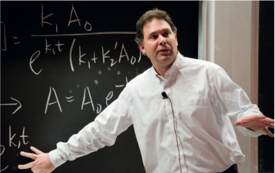 Andrei Tokmakoff, professor of chemistry, works through equations with students in Thermodynamics and Kinetics (5.60), which he co-teaches with Robert Silbey, also a professor of chemistry. The Energy Education Task Force provided support for expanding energy-focused content in this class, which enrolls about 150 students each year. 