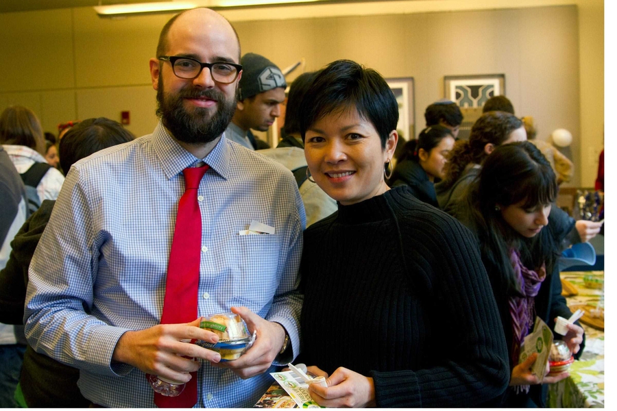 Sonia Liou and Jon Daries (research analysts for MIT Institutional Research) check out the hummus vendors and giveaways in the Bush Room. 