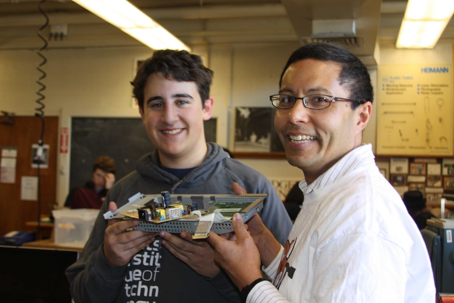 MIT freshman Danny Ben-David with Peter Mui ’82 holding the driver board from a flat screen monitor.