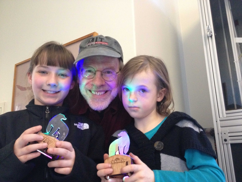 Stephanie Shoap and Lily Brinkman holding their Aurora Bearealis. In the center is Edgerton Center Instructor Ed Moriarty.