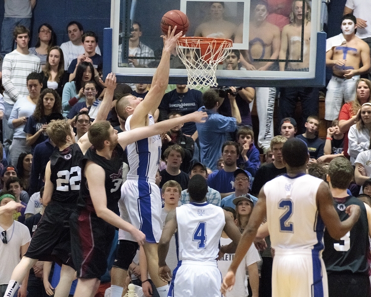 To make it to the Final Four, MIT first had to get past Franklin and Marshall College, which boasts the nation's best scoring defense and a roster of athletic players who slash their way to the rim. Here, F&M's Ed Early slips past seniors Dan McCue (#22) and Noel Hollingsworth for the dunk.
