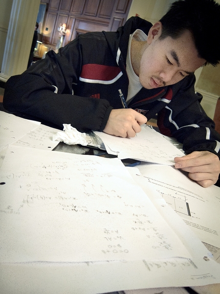 The MIT players were focused on taking care of business, on and off the court. Here, junior guard Cuong Nguyen works on a problem set in a hotel lounge on the morning of the big game.
