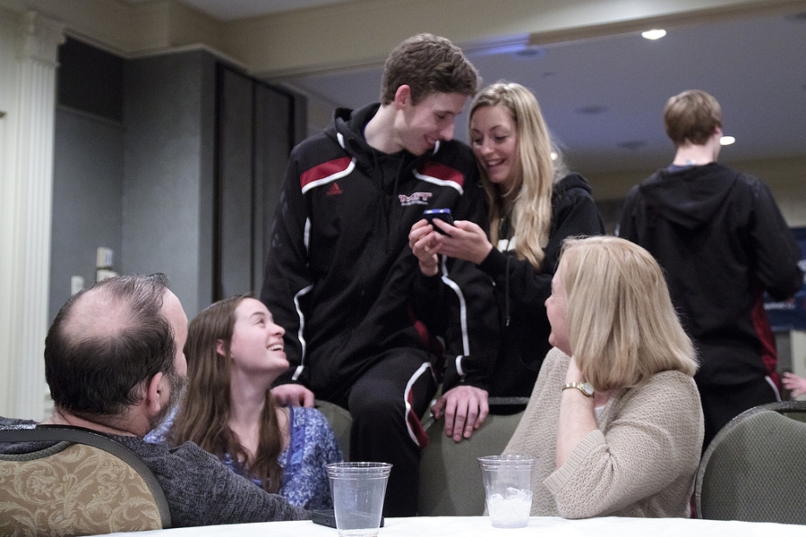 After a 31-game schedule and three weeks of NCAA tournament play, the team finally had a chance to relax with family and friends and to reflect on a championship season. Here, Jamie Karraker laughs with his parents, sister, and friend.
