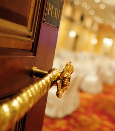 Close up of door handle and room in background