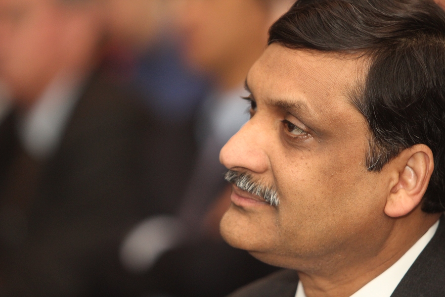 EdX President Anant Agarwal listens as the two presidents address the room.
