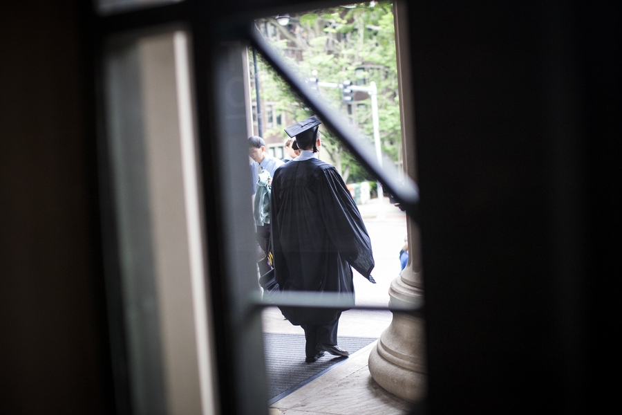 A graduating student walks out of Lobby 7 on the morning of the Commencement ceremony.