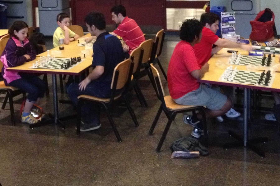 Tommy and Katie (far left) played chess weekly with The MIT Chess Club this past spring semester. Interacting with the college students got the two kids excited about college. 