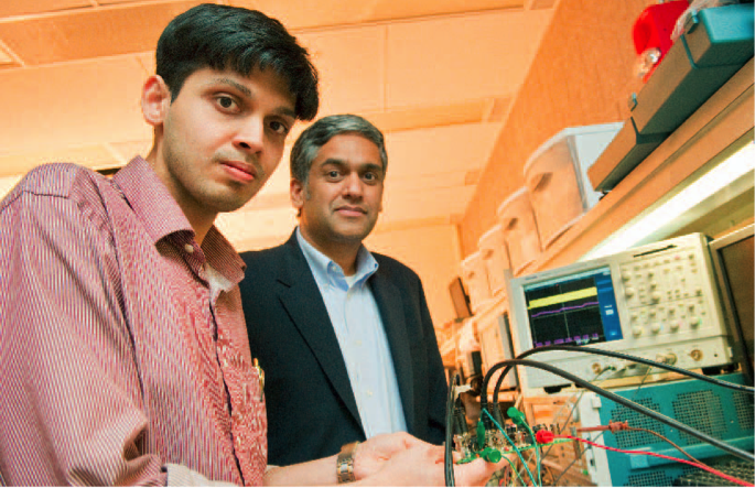 PhD student Saurav Bandyopadhyay, left, and Professor Anantha Chandrakasan showing the designed system.