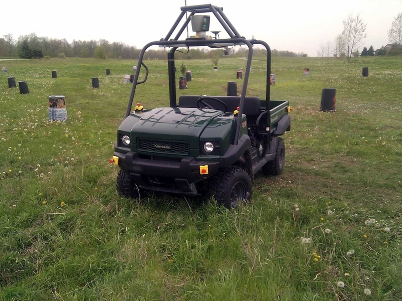 A utility vehicle equipped with a laser range finder drives through a field, avoiding obstacles without human intervention.