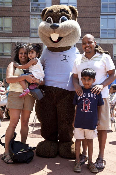 Tim the Beaver poses with Sham Sokka PhD '03 (right), the first president of Sidney-Pacific, and his family.