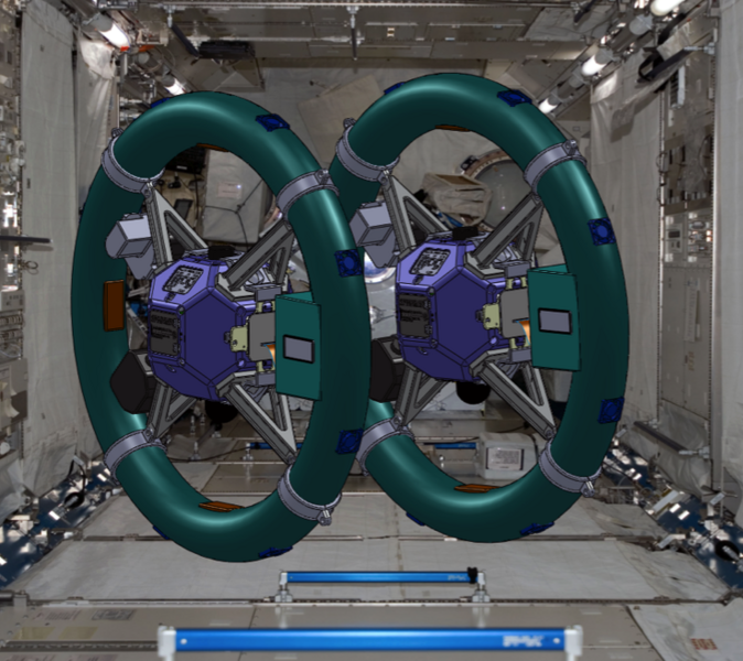 A rendering of two SPHERES, side by side, each surrounded by electromagnetic RINGS.