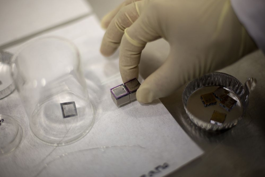 A pair of mini ion thrusters, including their propellant tanks, is prepared for tests.