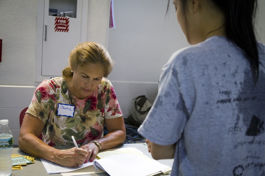Director of Physical Education Carrie Sampson Moore registers a student's successful completion of the swim test. For students who did not take the test during Orientation, Moore offers numerous opportunities throughout the year to pass the requirement.
