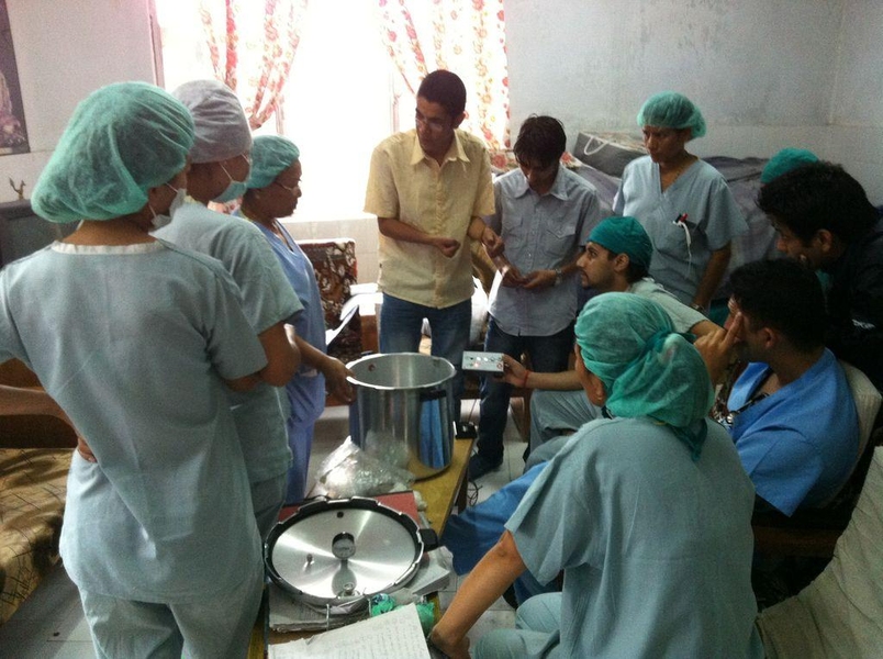 Staff in a Nepali health clinic discuss the autoclave prototype, which contains an intuitive interface and speaks in the native language.