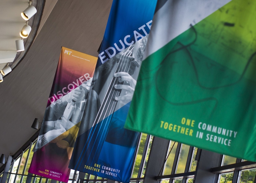 Banners hang from the lobby of Kresge Auditorium celebrating the Inauguration week's theme: One Community, Together in Service.