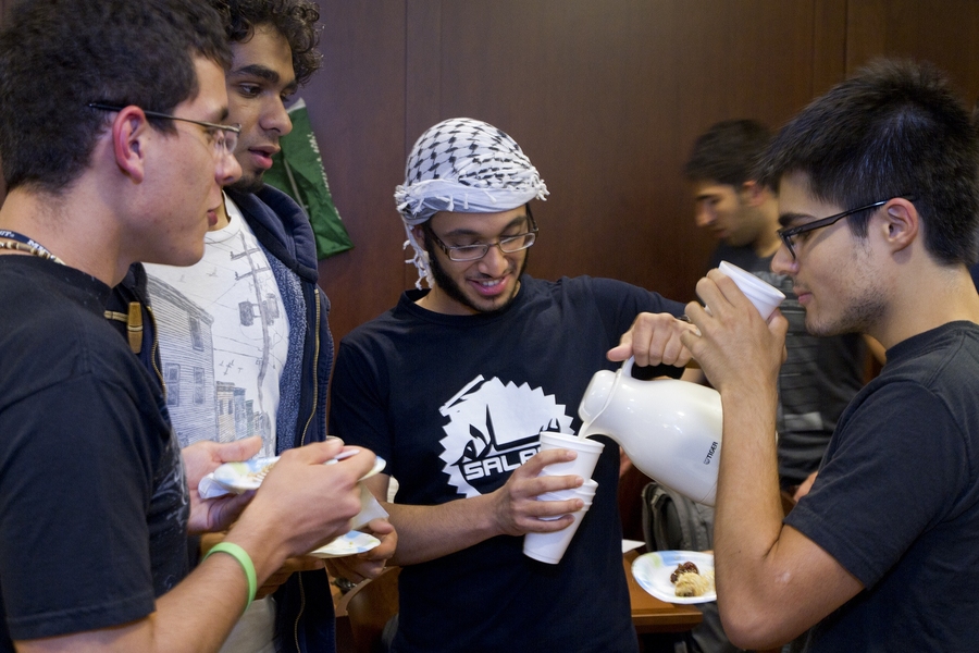 Abdulaziz-Aziz K Alghunaim '15, of Saudi Arabia, pours attendees some Arabian coffee — or, as he called it, 'real coffee.'