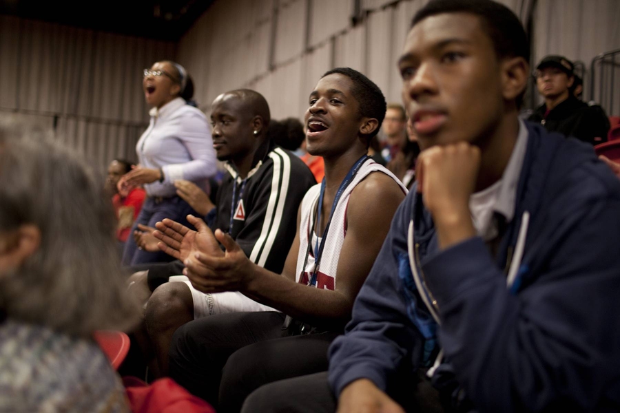 Kojo Welbeck '14 (center) cheers on the teams. The event also featured a shooting contest for prizes open to anyone in the stands.