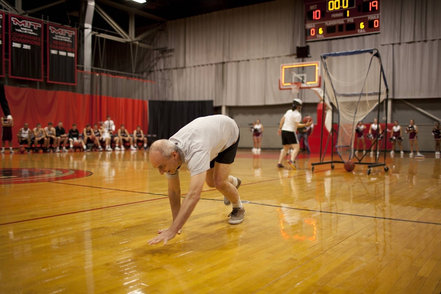 Two MIT staff members squared off against physics professor Peter Dourmashkin in a test of skills that ended with a half-court crawl to the finish.