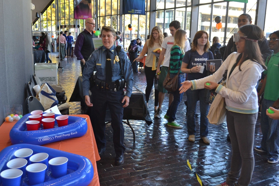 Of the nearly 20 organizations and departments represented at the MIT Wellness Fair, several featured fun giveaways or activities for students. In this photograph, Maiko Kitaoka '16 visited the MIT Police table where Sgt. Cheryl Vossmer spoke about alcohol awareness and safety.