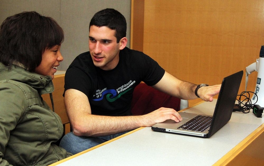 Angrist works with Achiever Carly Johnson, left, to finalize a short list of 17 colleges. Every Sunday, Amphibious Achievement mentors work with Achievers in their senior year of high school to compile college lists, write college essays and submit the Free Application for Federal Student Aid. Although the day is long, from 8:30 a.m. to 2 p.m., it's worth the effort.