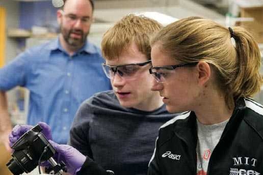 Professor Michael Strano watches as Marie Burkland ’13 (right) and Jared Forman ’13 set up a camera to capture images of a thermopower wave being launched by an “electric match," a device they designed and built. 