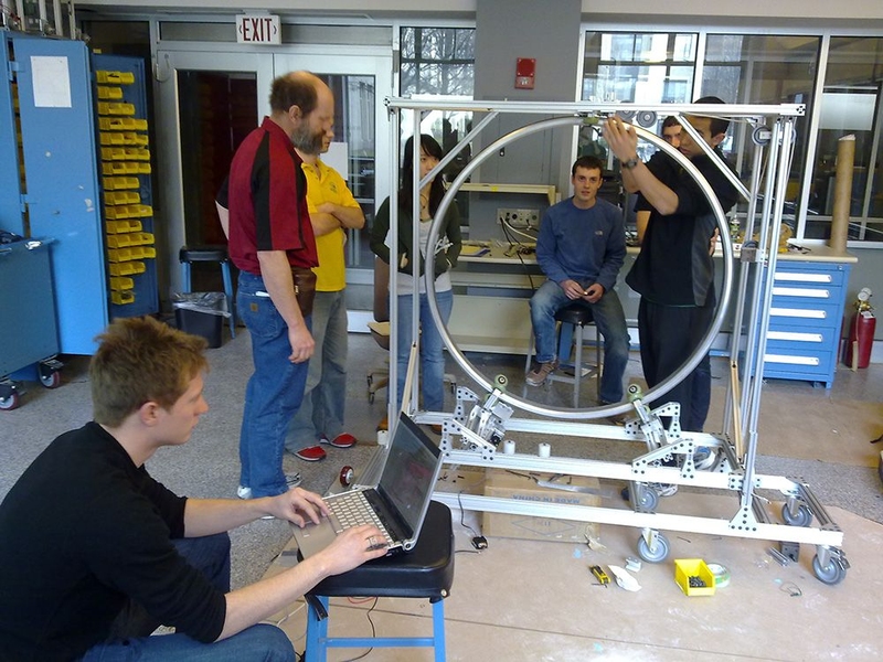 A student team in the Precision Machine Design class in 2009 works on assembling hardware for new medical imaging equipment being developed at Massachusetts General Hospital. Alex Slocum, standing at left, has taught the class since it began in 2004.